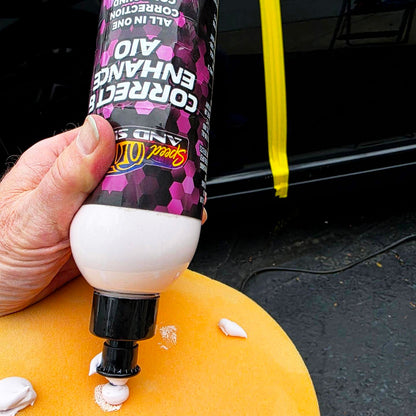 A hand holds a tube of Speed And Shine Correct & Enhance AIO 16 oz