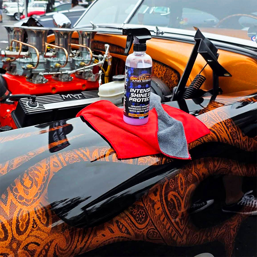 A bottle of Intense Shine & Protect sits on a microfiber cloth on the hood of a car