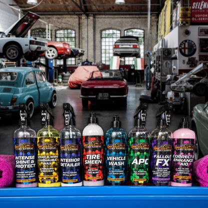 A row of 8 Speed And Shine professional car care products lined up in a garage setting.